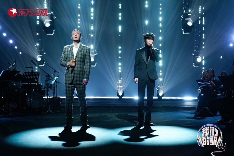 男人站在舞台上表演的几个人中度可信度描述已自动生成